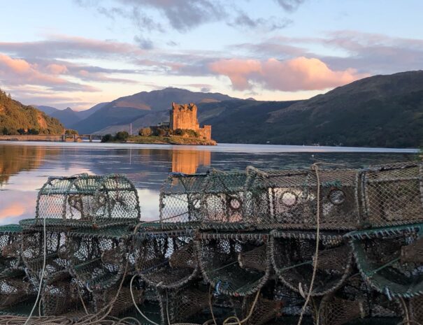 Fishing creels from today's fresh catch on the shores in front of Eilean Donan Castle - authentic Scottish experiences with ASB Chauffeur Drive Scotland